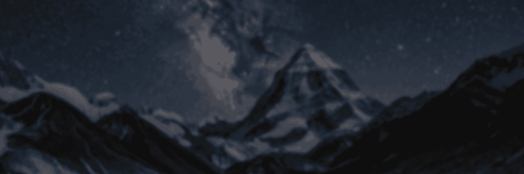 A snow-covered mountain peak under a night sky filled with stars and a visible section of the Milky Way.